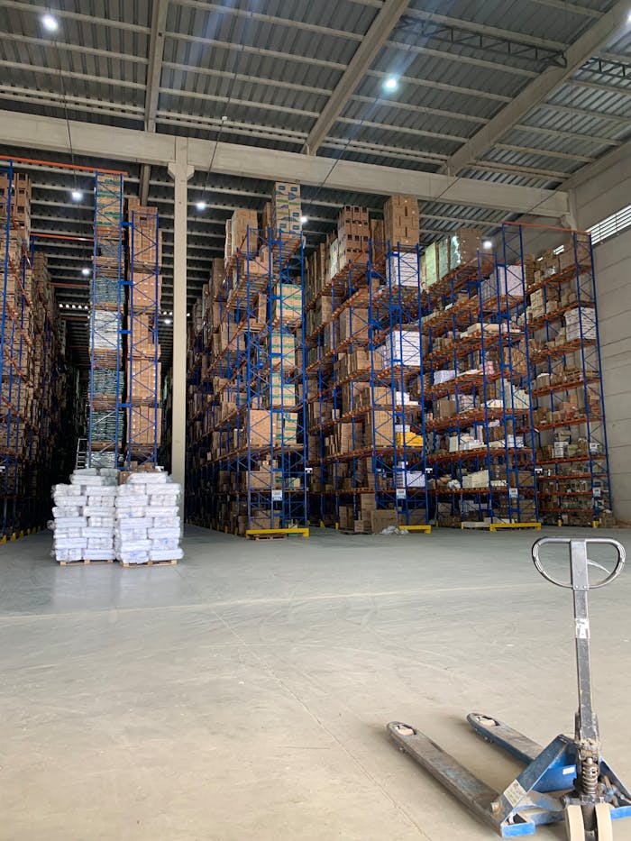 A large warehouse filled with stacked pallets of goods, showcasing industrial storage.